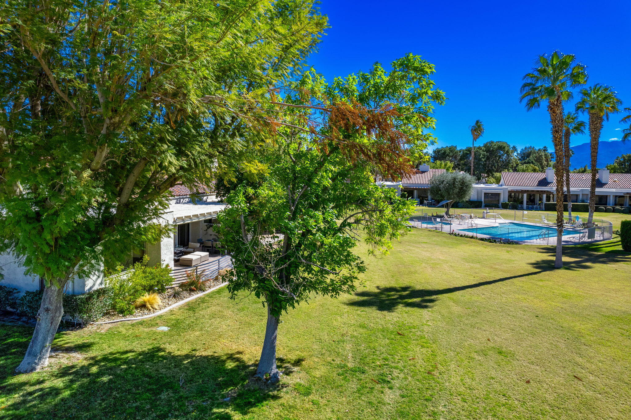717 Inverness Drive Rancho Mirage, CA 92270 - Photo 38 of 46 a view of a swimming pool with a yard