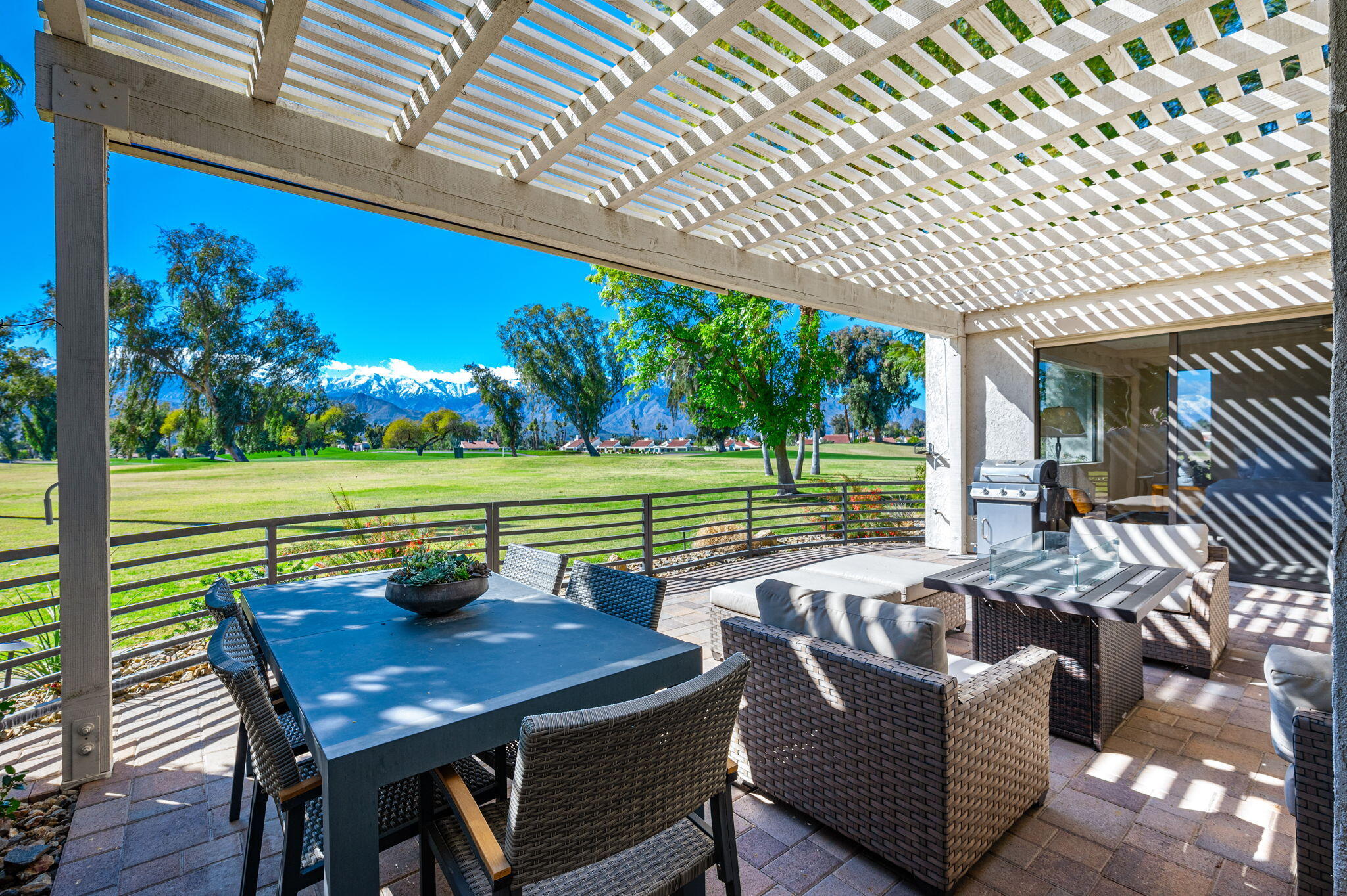 717 Inverness Drive Rancho Mirage, CA 92270 - Photo 43 of 46 a view of a patio with table and chairs with wooden floor and fence