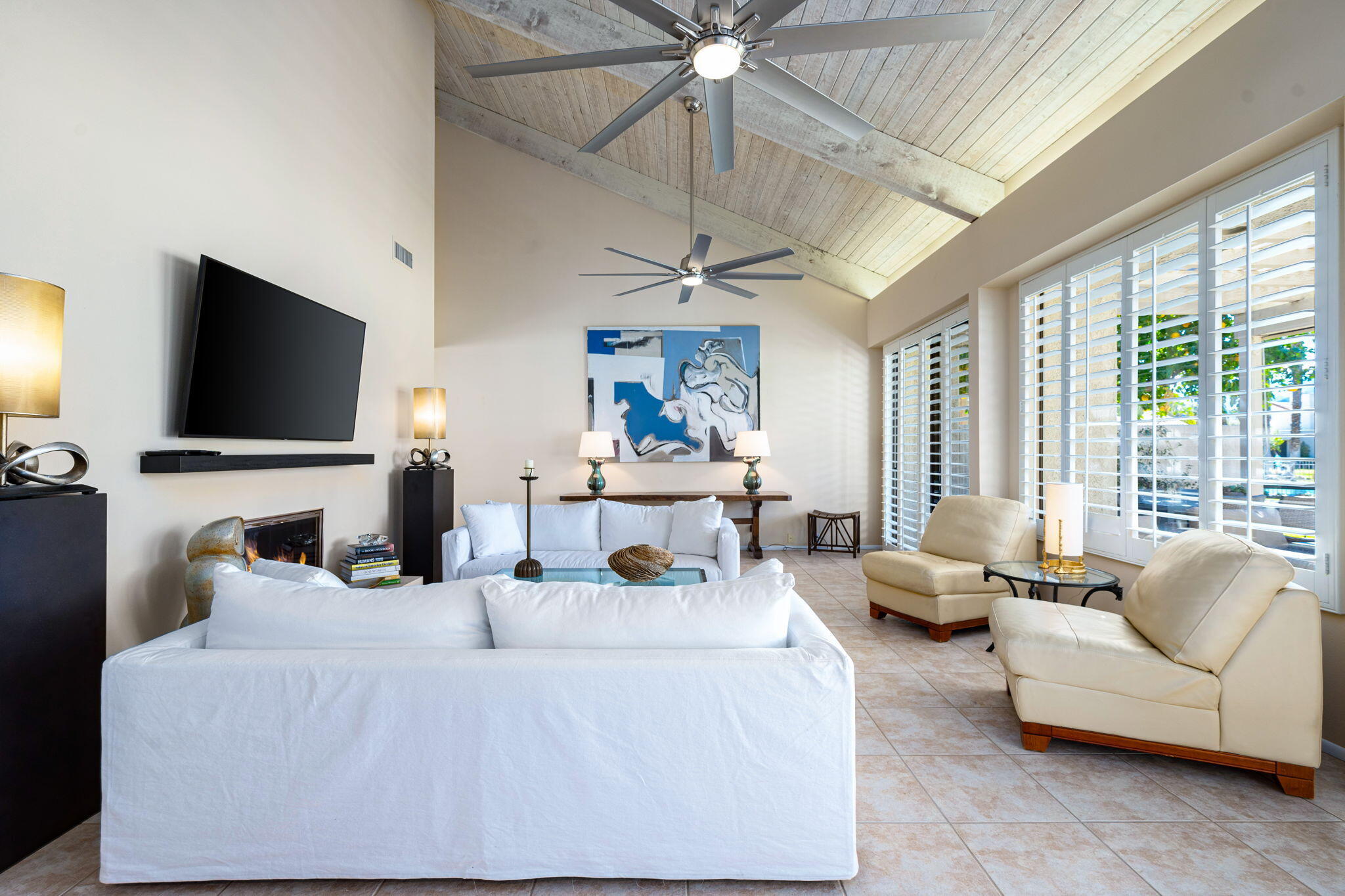 717 Inverness Drive Rancho Mirage, CA 92270 - Photo 5 of 46 a living room with furniture a flat screen tv and a large window