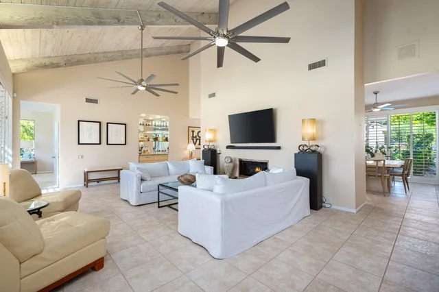 a living room with fireplace furniture and a flat screen tv