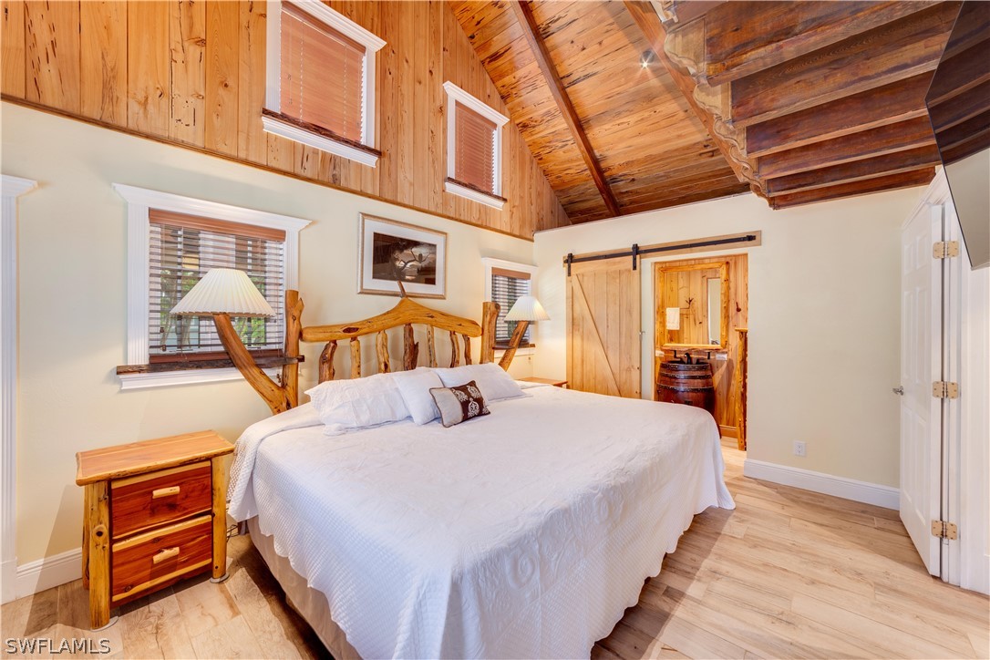 7146 Congdon Road Fort Myers, FL 33908 - Photo 15 of 50 a bedroom with bed and wooden floor