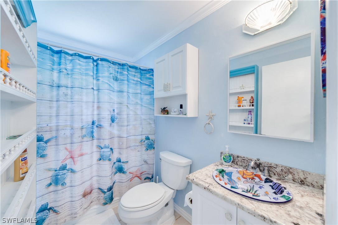 7146 Congdon Road Fort Myers, FL 33908 - Photo 31 of 50 a bathroom with a sink a toilet and shower curtain