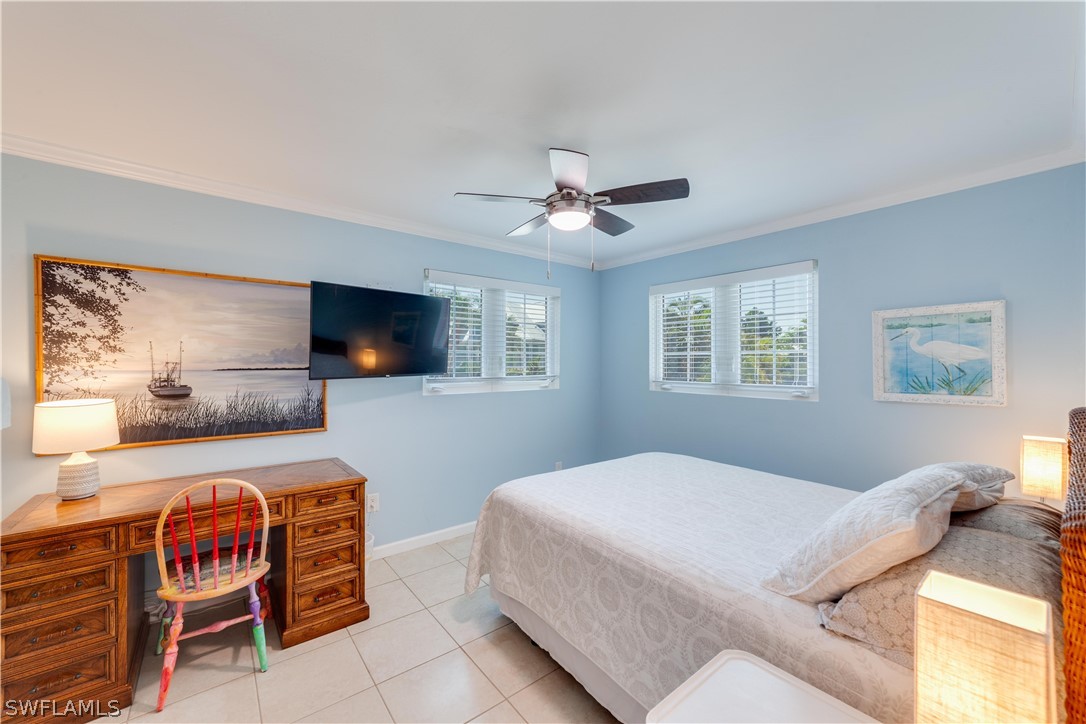 7146 Congdon Road Fort Myers, FL 33908 - Photo 32 of 50 a bedroom with a bed and a flat screen tv