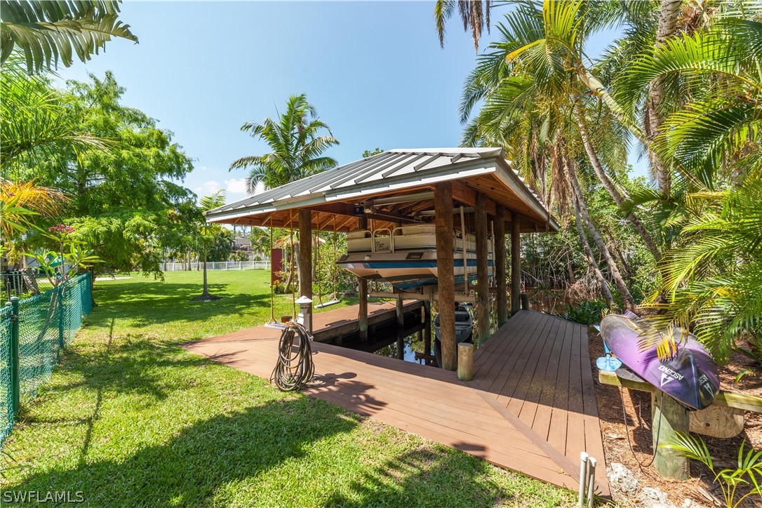 7146 Congdon Road Fort Myers, FL 33908 - Photo 39 of 50 a backyard of a house with barbeque oven table and chairs