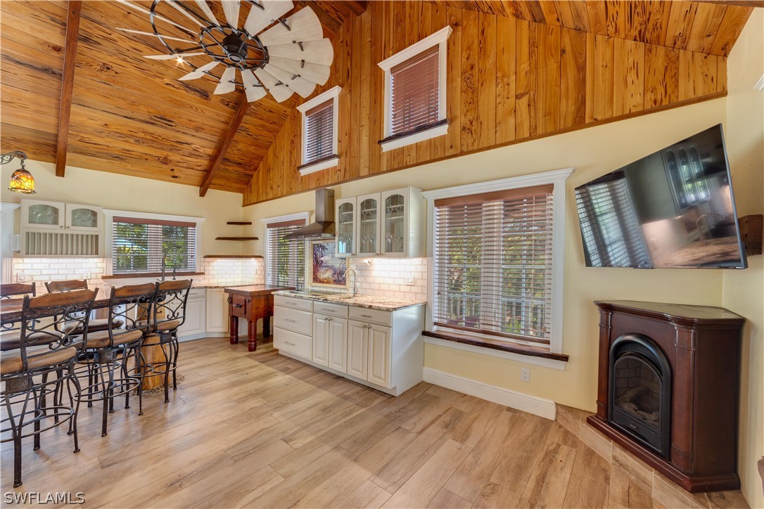 7146 Congdon Road Fort Myers, FL 33908 - Photo 7 of 50 a living room with furniture a flat screen tv and a fireplace