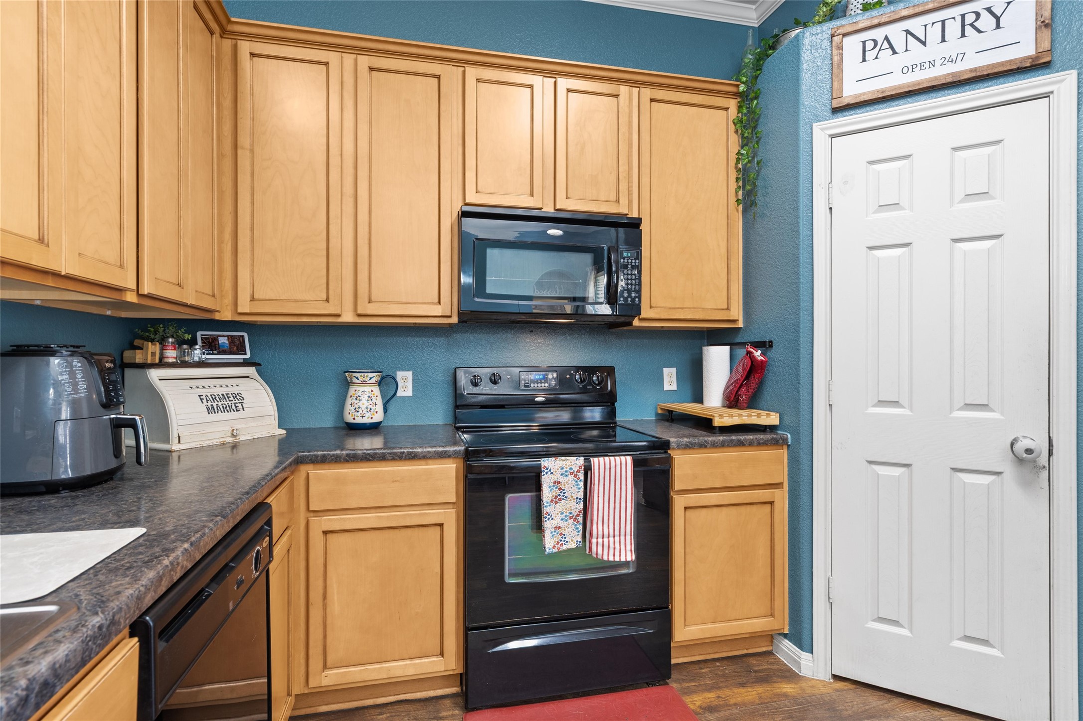 149 Dropper Kyle, TX 78640 - Photo 14 of 33 A classic kitchen setup features ample wooden cabinetry and durable stone counters.