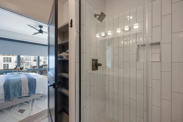 a bathroom with a shower a sink and mirror