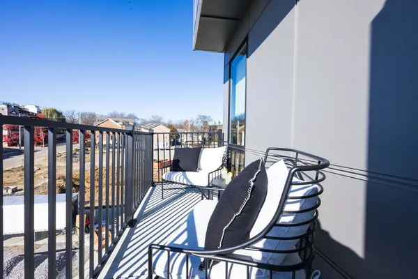 a view of a balcony with chairs
