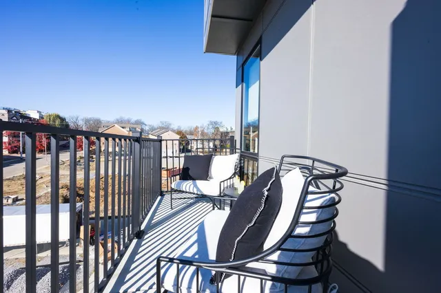 a view of a balcony with chairs