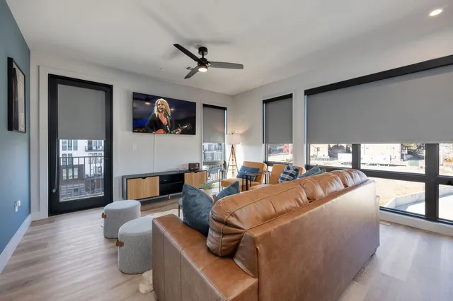 a living room with fireplace furniture and a flat screen tv