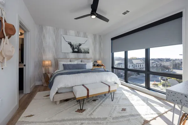 a bedroom with a large bed and a window