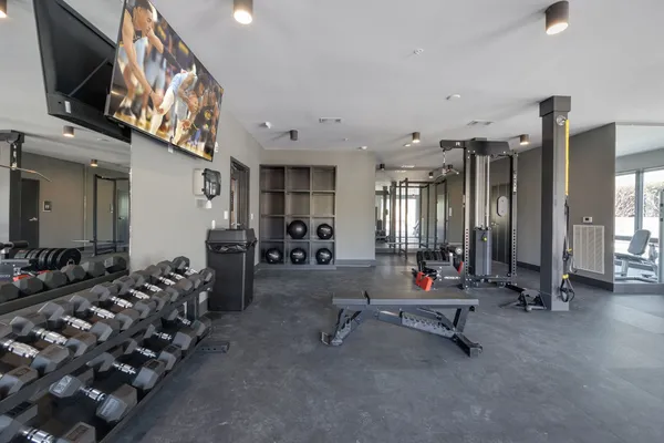a gym room with lots of gym equipment