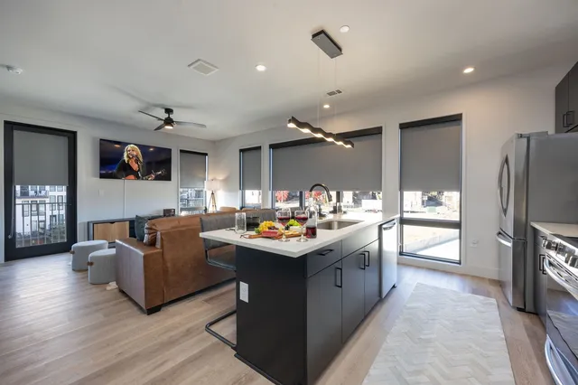 a living room with granite countertop furniture and a flat screen tv