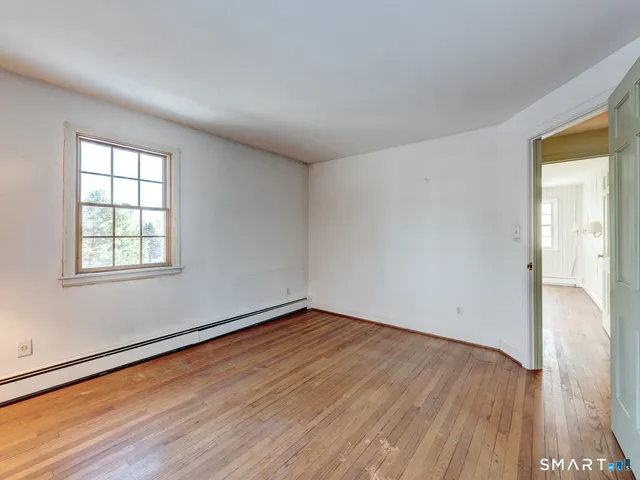 a bathroom with a granite countertop sink a mirror a bathtub and shower
