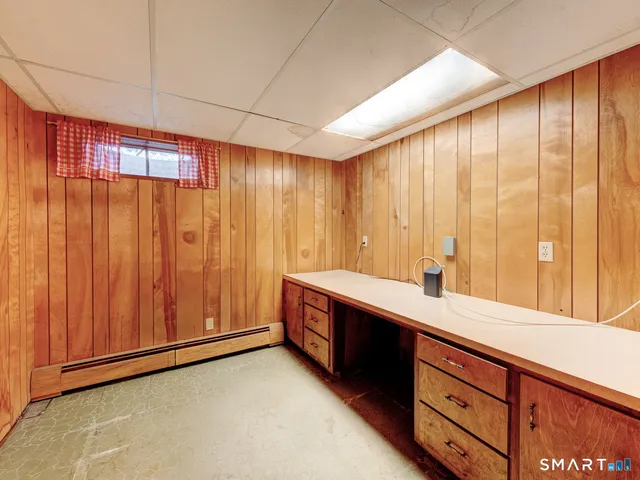 a view of a house with a snow in front of yard and trees