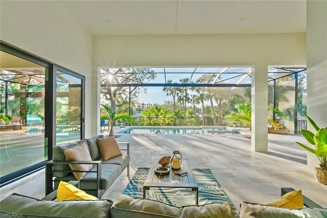 a living room with furniture and a floor to ceiling window