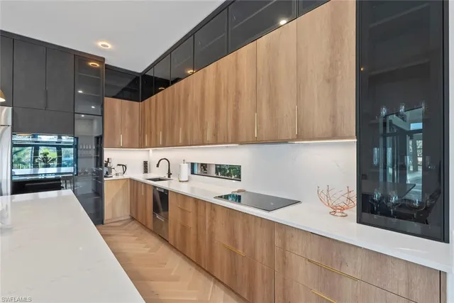 a kitchen with a sink a counter top space and cabinets