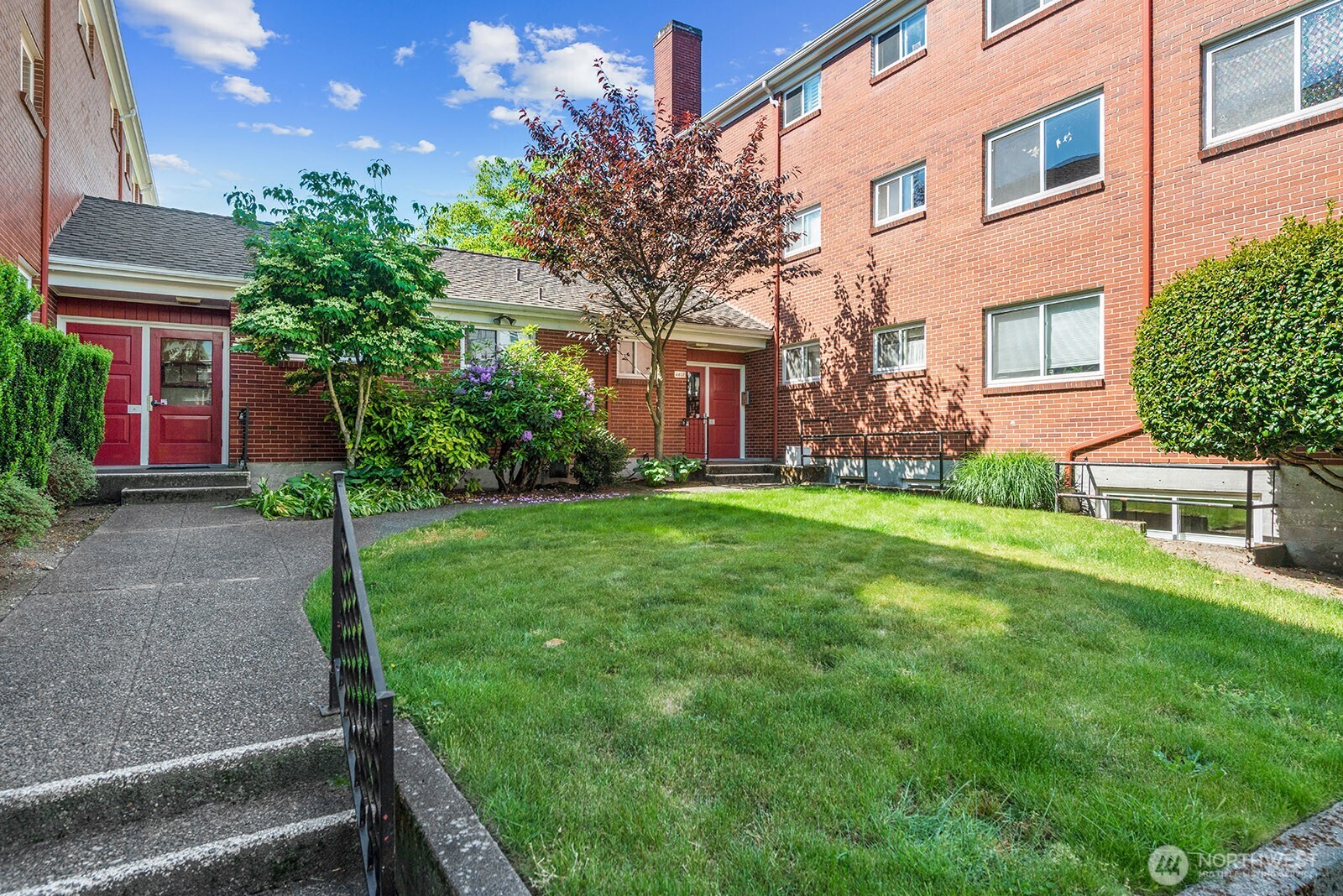 4407 Southwest Alaska Street, Unit 11 Seattle, WA 98116 - Photo 16 of 24 a view of a house with a yard and tree s