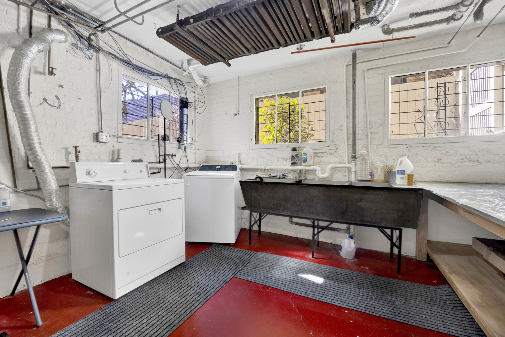 931 West Winona Street, Unit GDN Chicago, IL 60640 - Photo 15 of 18 a living room with stainless steel appliances kitchen island granite countertop furniture a sink a rug and a window