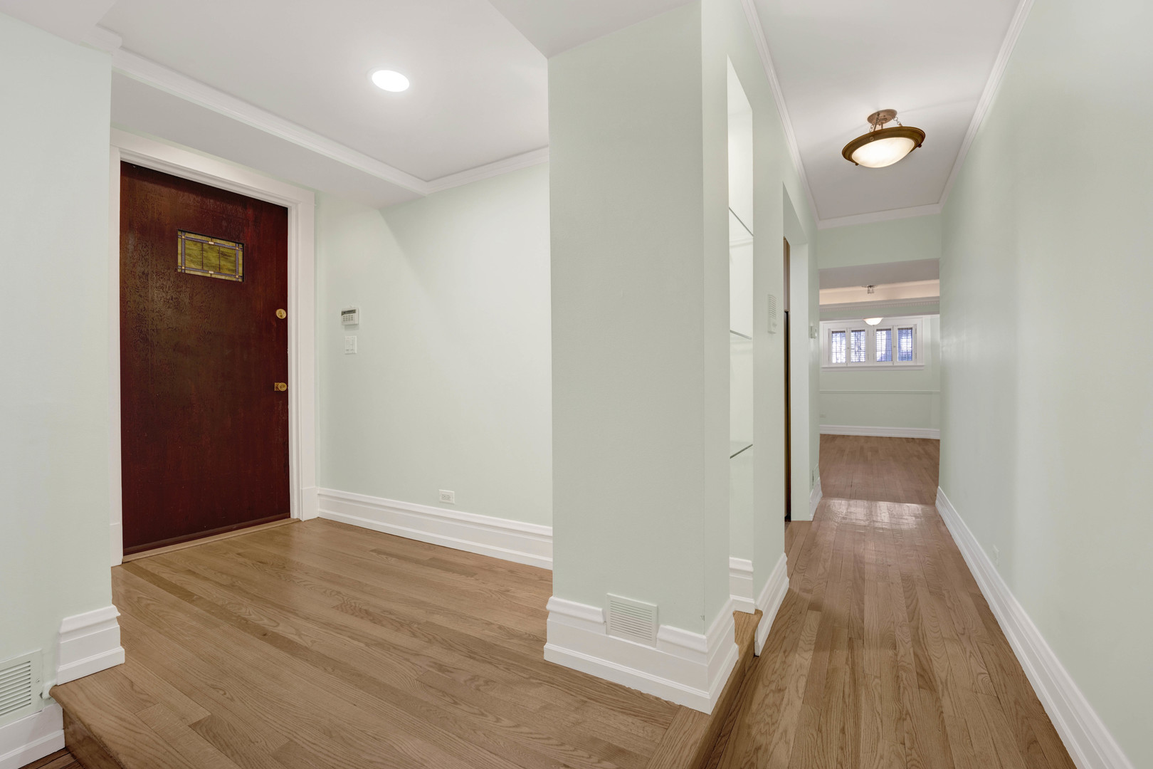 931 West Winona Street, Unit GDN Chicago, IL 60640 - Photo 17 of 18 a view of a hallway with wooden floor
