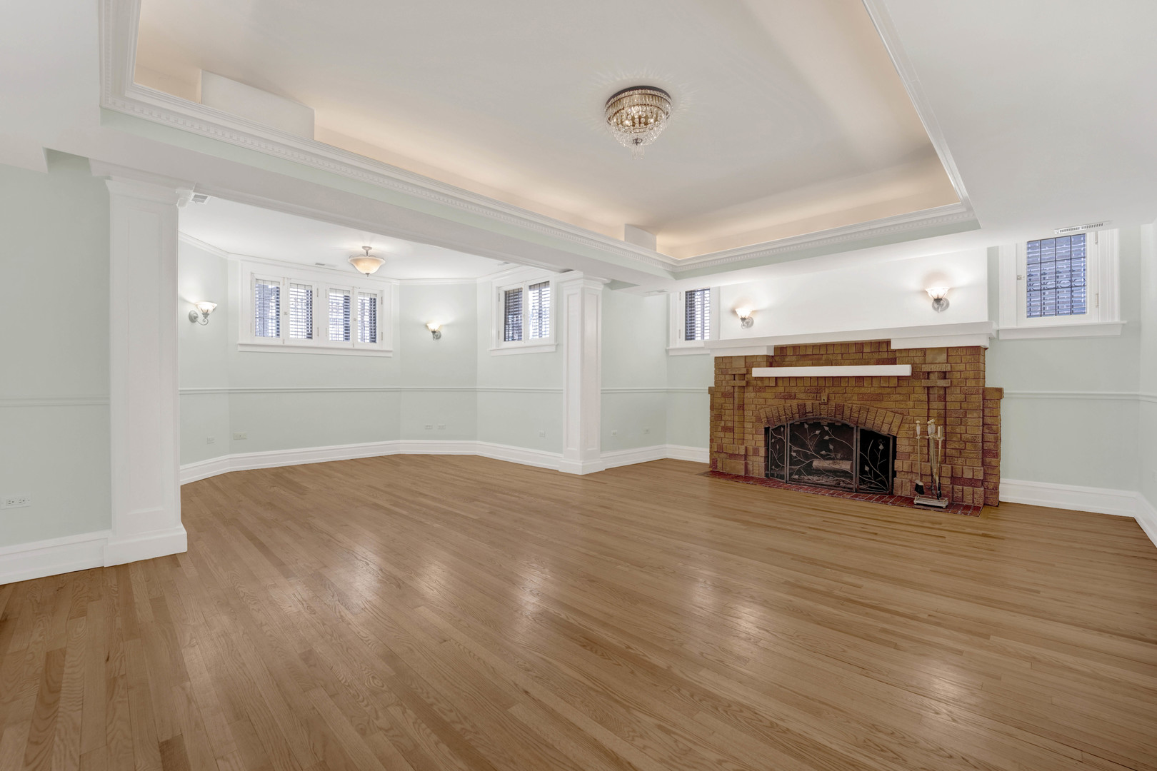 931 West Winona Street, Unit GDN Chicago, IL 60640 - Photo 2 of 18 a view of empty room with fireplace and wooden floor