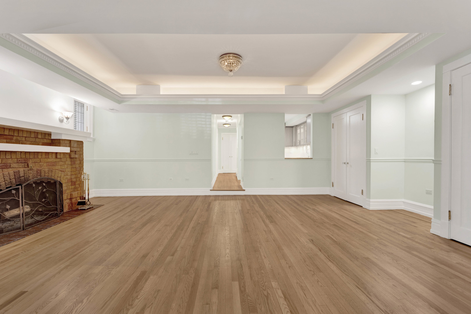 931 West Winona Street, Unit GDN Chicago, IL 60640 - Photo 3 of 18 an empty room with wooden floor and fireplace