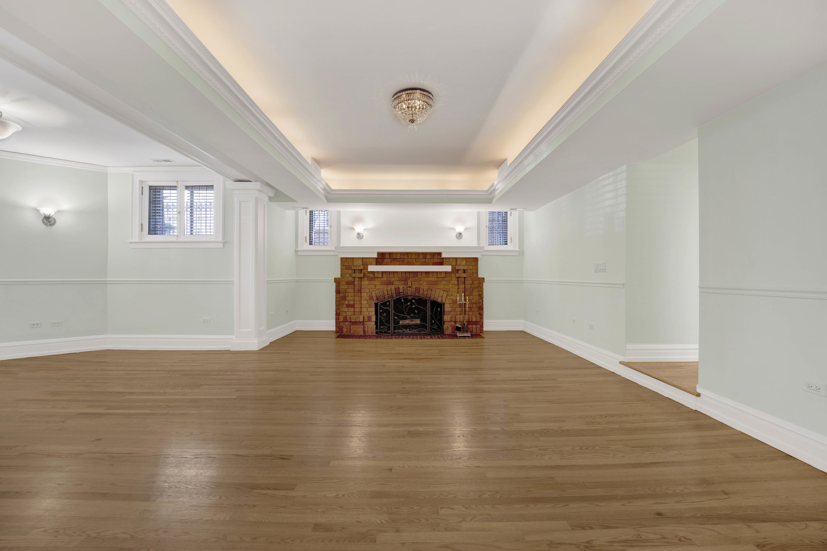 931 West Winona Street, Unit GDN Chicago, IL 60640 - Photo 5 of 18 a view of empty room with wooden floor fireplace and window
