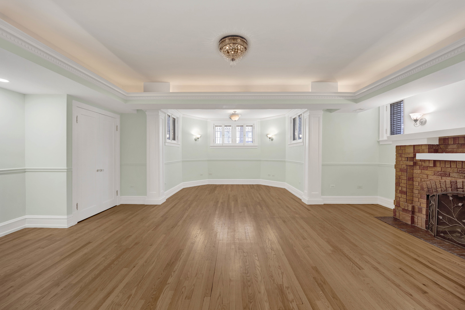 931 West Winona Street, Unit GDN Chicago, IL 60640 - Photo 6 of 18 wooden floor in an empty room with a fireplace