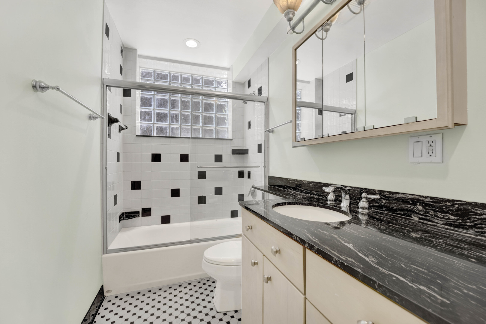931 West Winona Street, Unit GDN Chicago, IL 60640 - Photo 10 of 18 a bathroom with a granite countertop sink a toilet and a bathtub