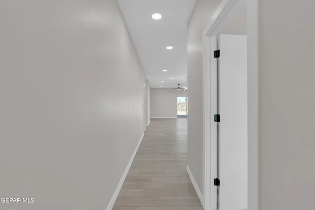 a view of a hallway with wooden floor
