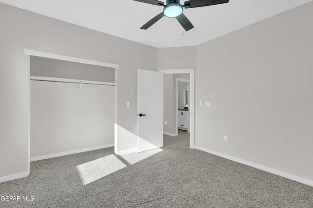 a view of a room with a ceiling fan