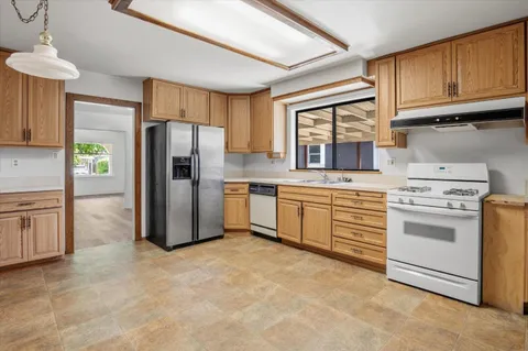 a kitchen with a stove sink and refrigerator
