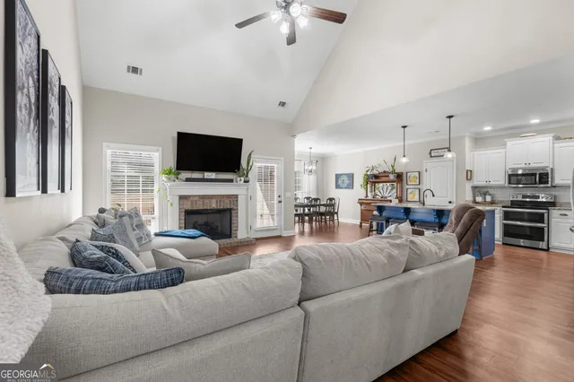 a living room with furniture a fireplace and a flat screen tv