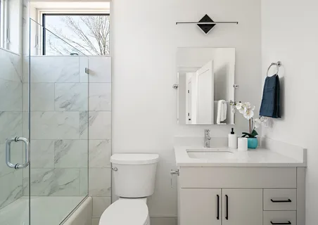 a bathroom with a toilet sink and shower