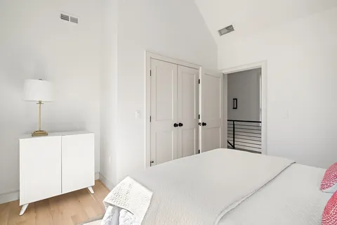 a bedroom with a bed and a lamp