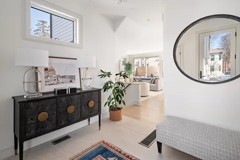a living room with furniture and a mirror