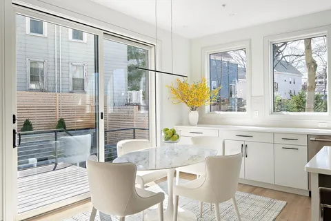 a dining area with a granite countertop sink and a large window