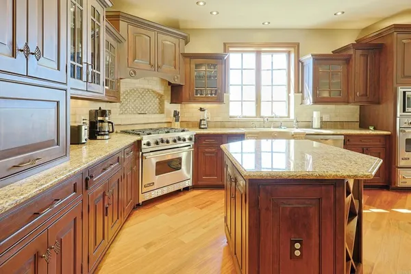 a kitchen with stainless steel appliances granite countertop a stove sink and cabinets