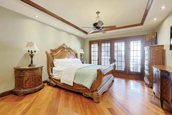 a bedroom with a bed and a chandelier