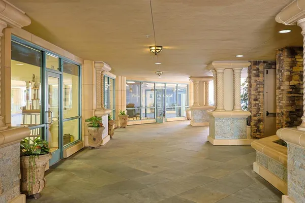 a living room with furniture and large windows