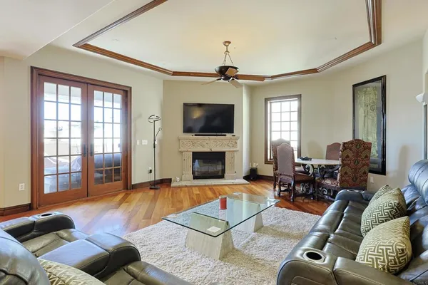 a living room with furniture a flat screen tv and a fireplace