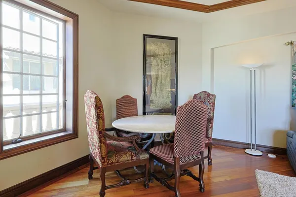 a view of a dining room with furniture window and wooden floor