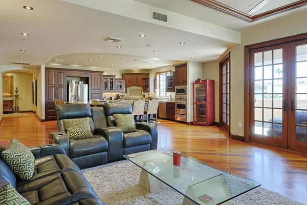a living room with furniture and a wooden floor