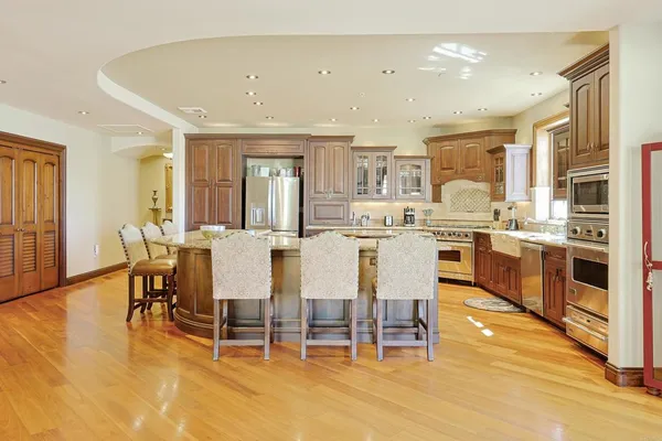 a large kitchen with a table and chairs