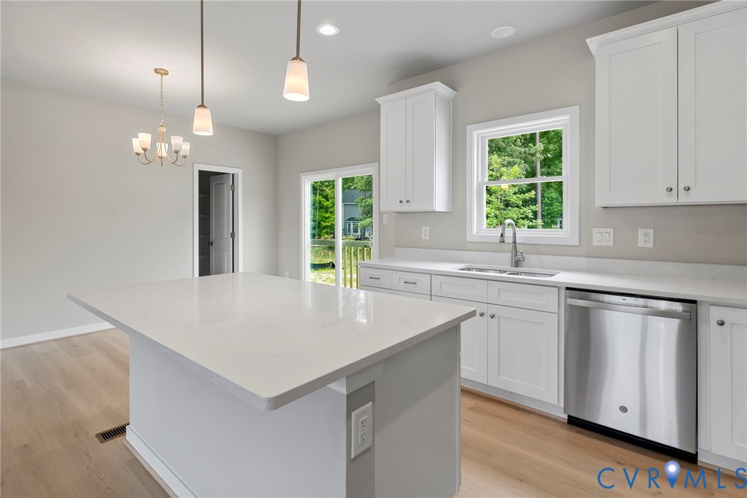 8201 Excaliber Place North Chesterfield, VA 23237 - Photo 3 of 12 a kitchen with kitchen island granite countertop a sink a counter top space and living room view