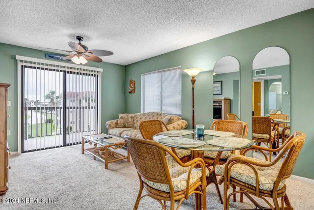 a view of a dining room with furniture and a large window