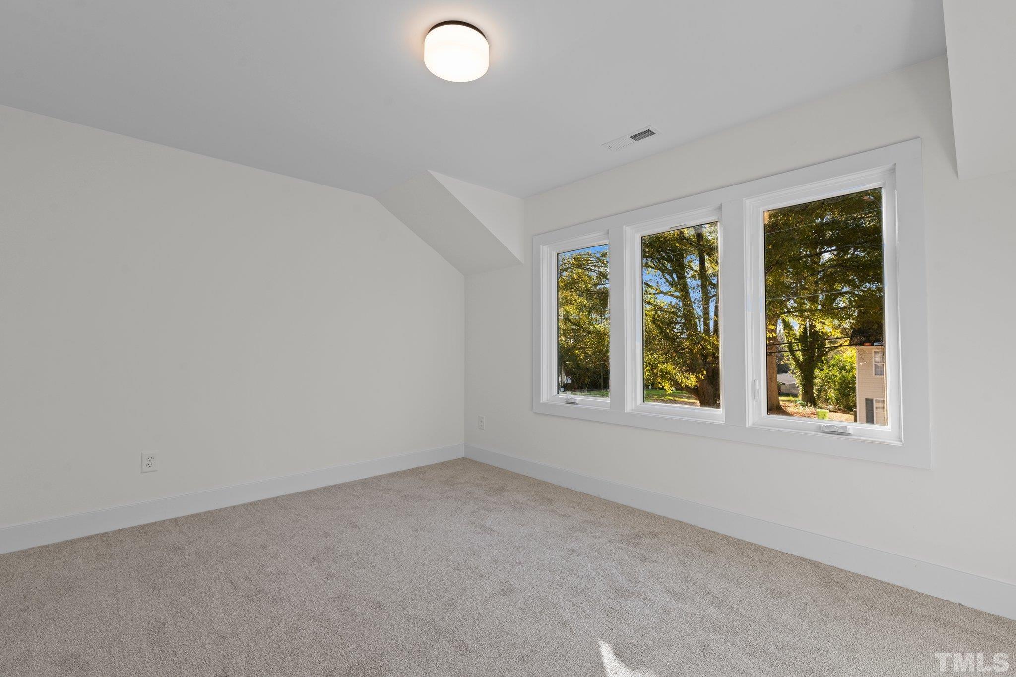 829 Cumberland Street, Unit 100 Raleigh, NC 27610 - Photo 20 of 31 an empty room with windows