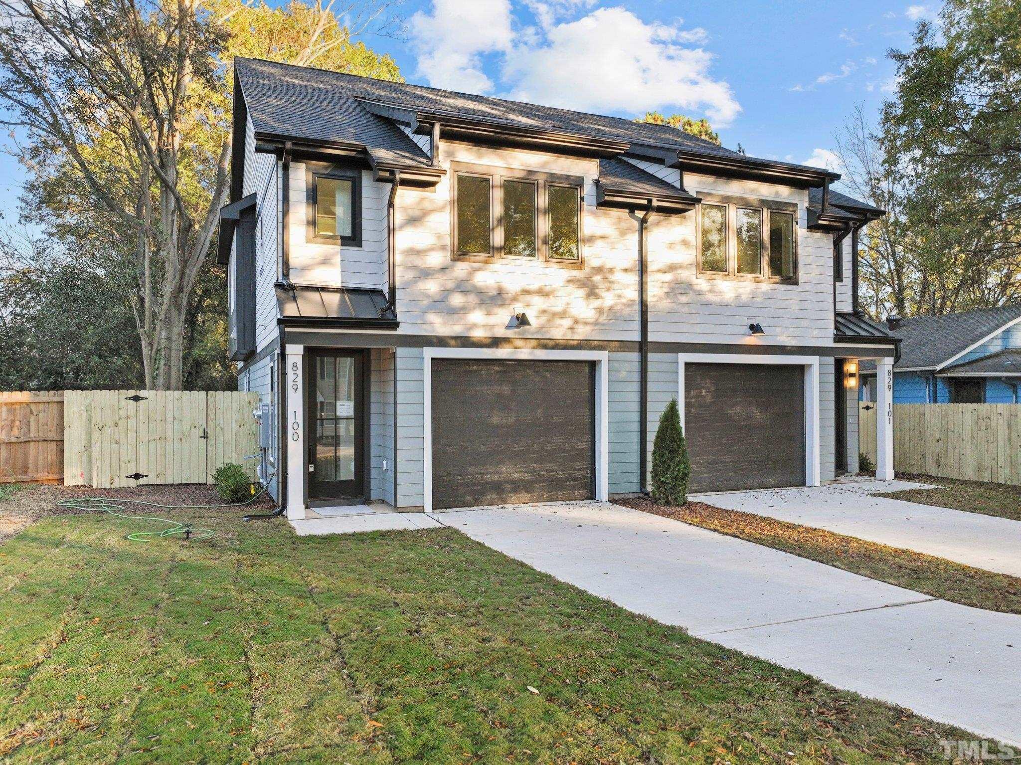 829 Cumberland Street, Unit 100 Raleigh, NC 27610 - Photo 2 of 31 a front view of a house with a yard