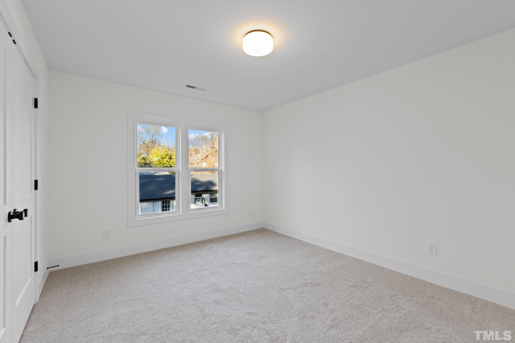 829 Cumberland Street, Unit 100 Raleigh, NC 27610 - Photo 25 of 31 an empty room with a window
