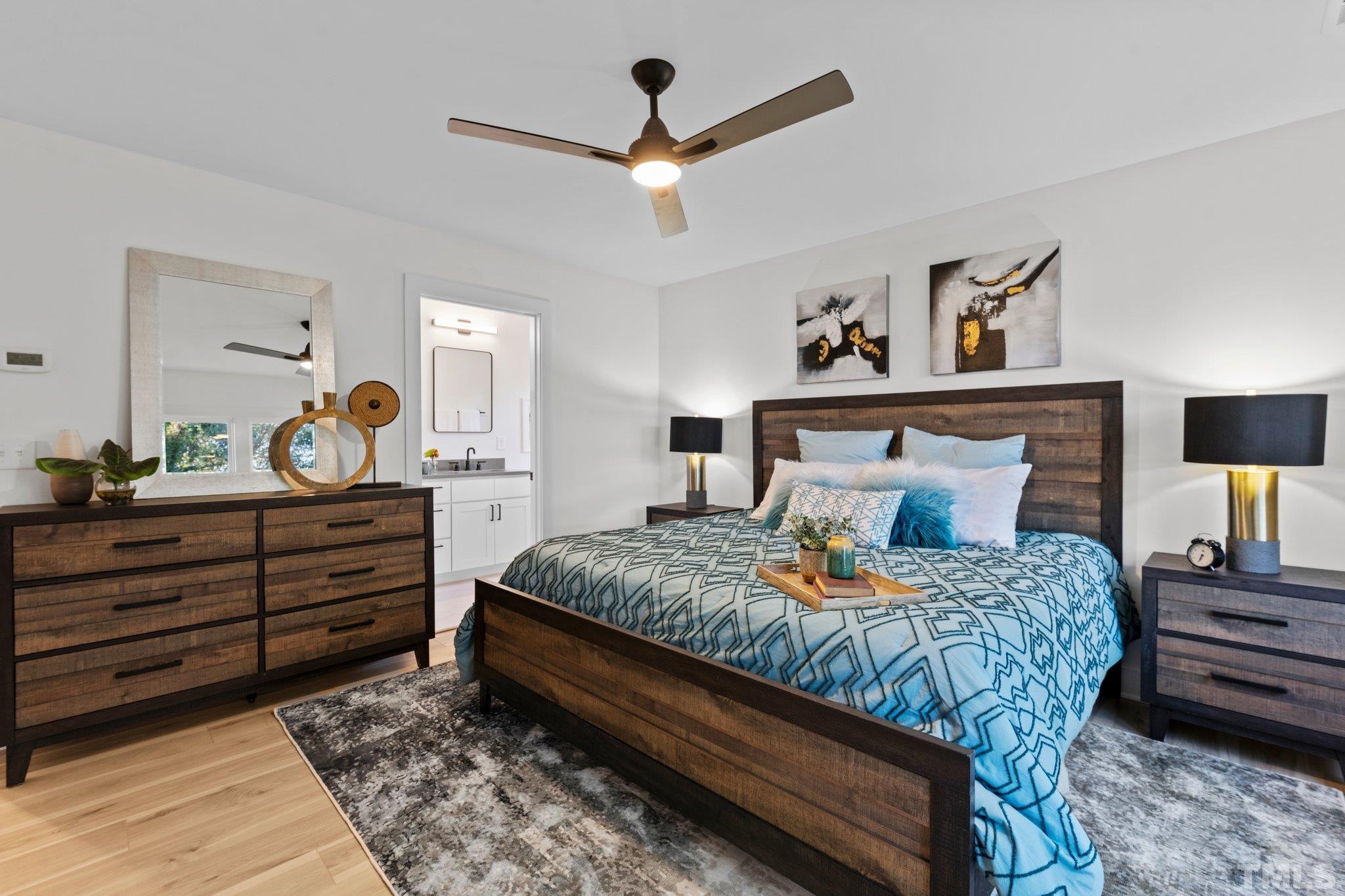829 Cumberland Street, Unit 100 Raleigh, NC 27610 - Photo 29 of 31 a bedroom with a bed and a chandelier
